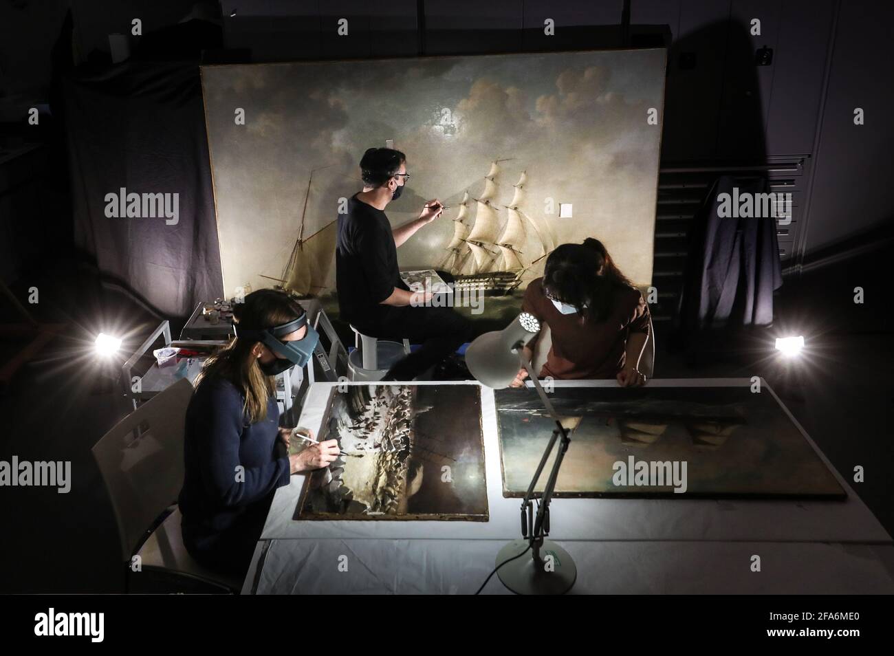 Accredited Paintings Conservator Rhiannon Clarricoates (left) working