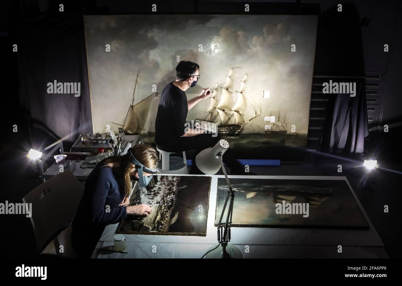 Accredited Paintings Conservator Rhiannon Clarricoates (left) working