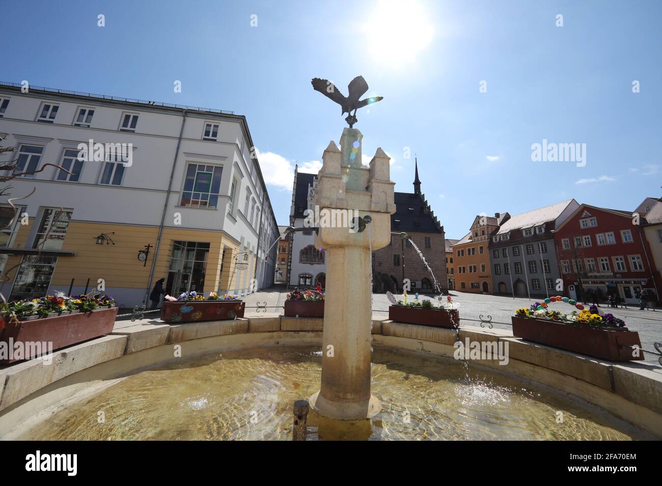 23 April 2021, Thuringia, Neustadt an der Orla: The fountain in the town's market square is decorated with colourful flowers. The district Saale-Orla-Kreis (TH) has the highest 7-day incidence in Germany with 377.3. (as of 23.04.2021) Photo: Bodo Schackow/dpa-Zentralbild/dpa Stock Photo