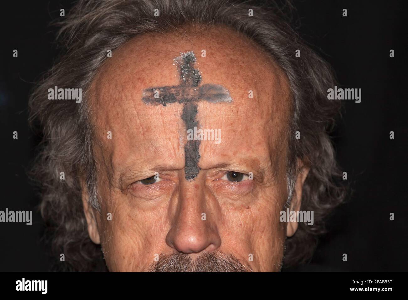 Fanatical prayer with ash cross on his forehead Stock Photo Alamy