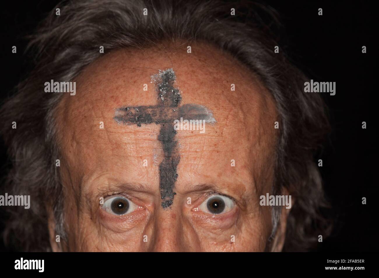 Fanatical prayer with ash cross on his forehead Stock Photo Alamy