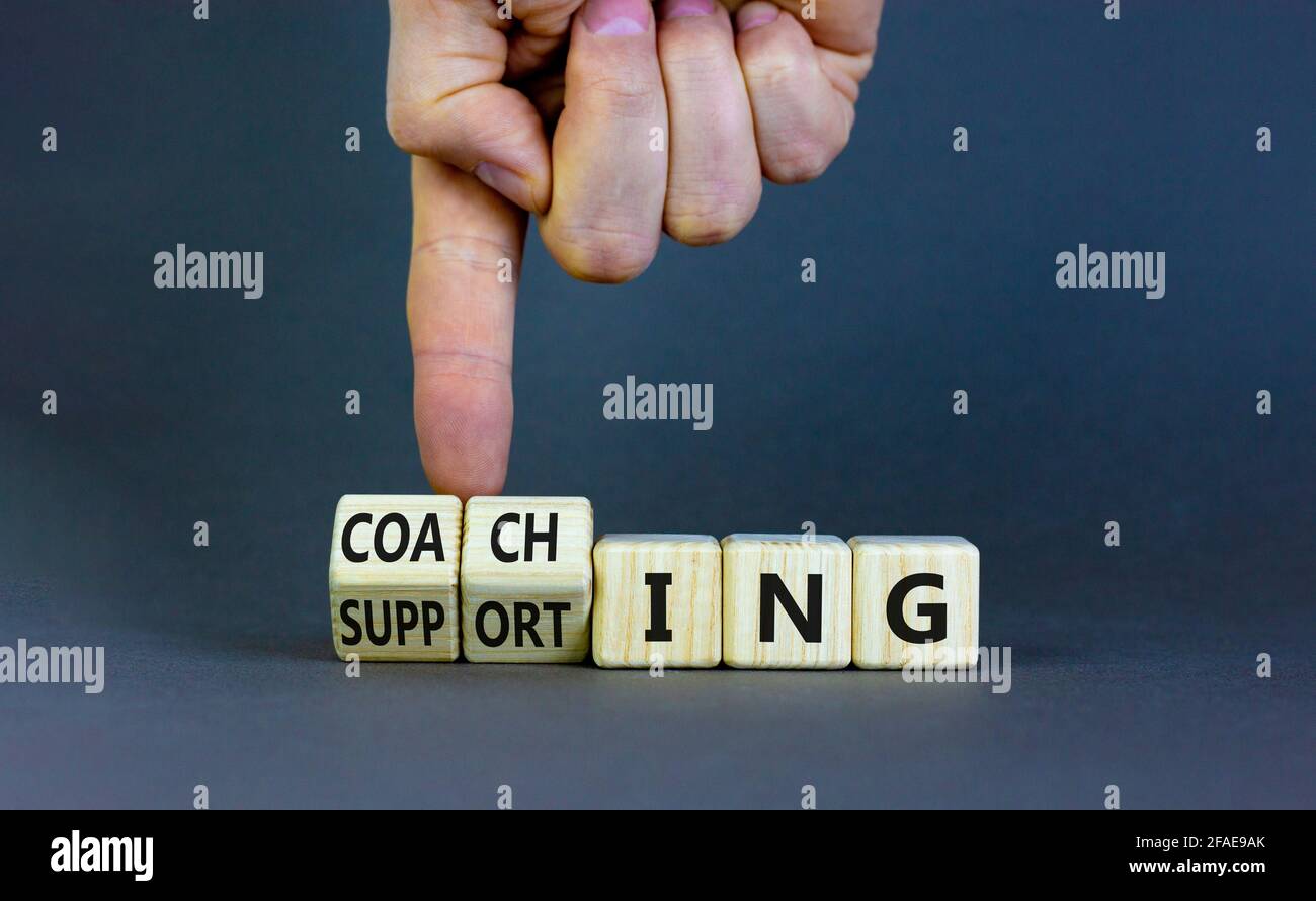Coaching or supporting leadership style symbol. Businessman turns cubes ...