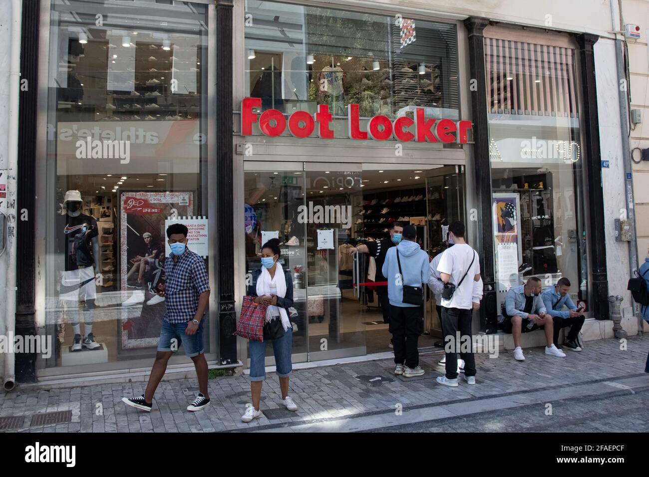 People seen waiting outside a Foot Locker store at Ermou street close to Syntagma square. Stock Photo