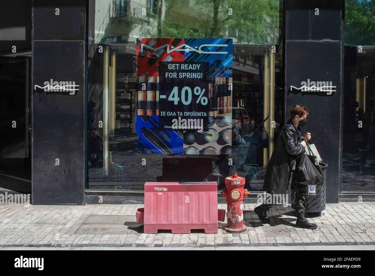 A man seen walking past a MAC Cosmetics store at Ermou street close to Syntagma square. Stock Photo