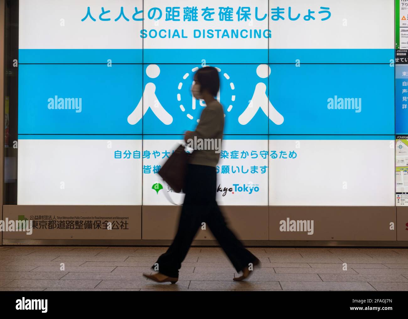 Tokyo 23rd Apr 21 A Woman Walks Past A Social Distancing Signage In Tokyo Japan On April 23 21 Japan S Prime Minister Yoshihide Suga On Friday Declared A Third State Of Emergency
