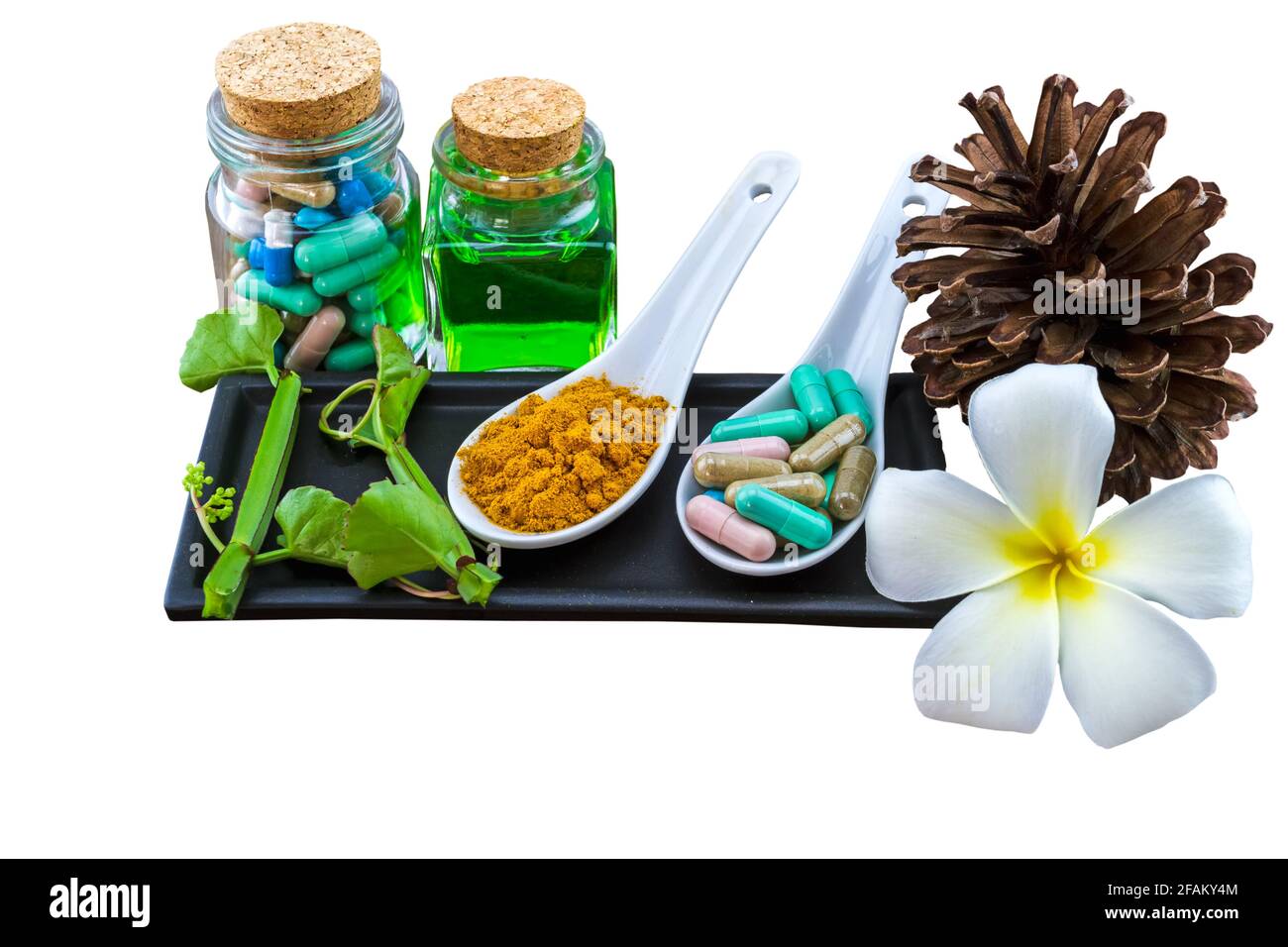 Spa herbal (white frangipani flowers, turmeric powder in white spoon ,pill,Cissus Quadrangularis Linn,pine,Aloe vera essential oil ) isolated on white Stock Photo
