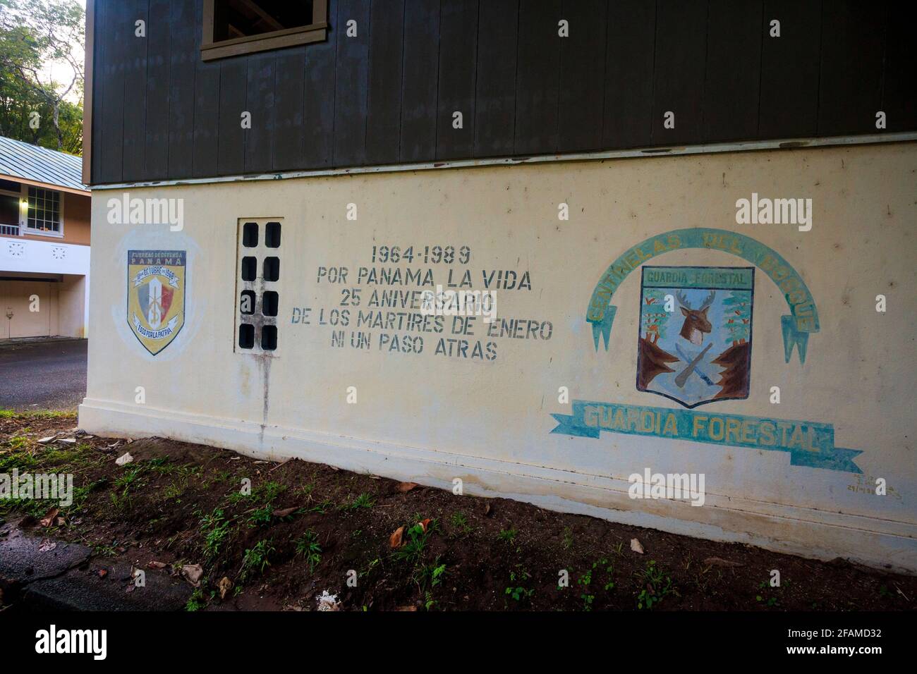 Wall painting with banners and text on the old police station building in the town of Gamboa, Colon province, Republic of Panama, Central America. Stock Photo
