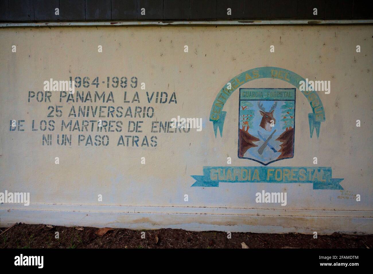 Wall painting with banner and text on the old police station building in the town of Gamboa, Colon province, Republic of Panama, Central America. Stock Photo