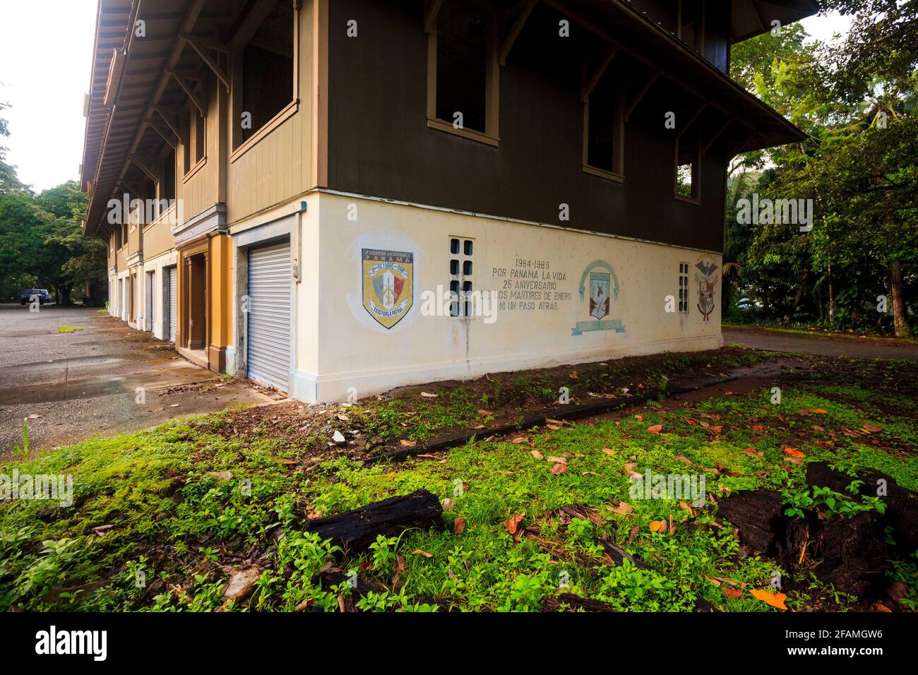 Wall painting with banners and text on the old police station building in the town of Gamboa, Colon province, Republic of Panama, Central America. Stock Photo