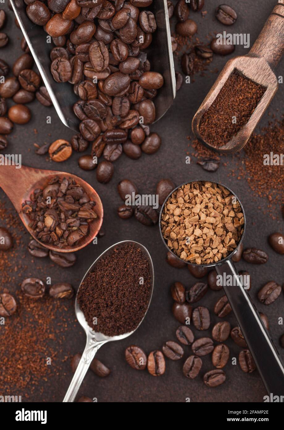 Various scoops with ground and bean coffee and freeze dried instant