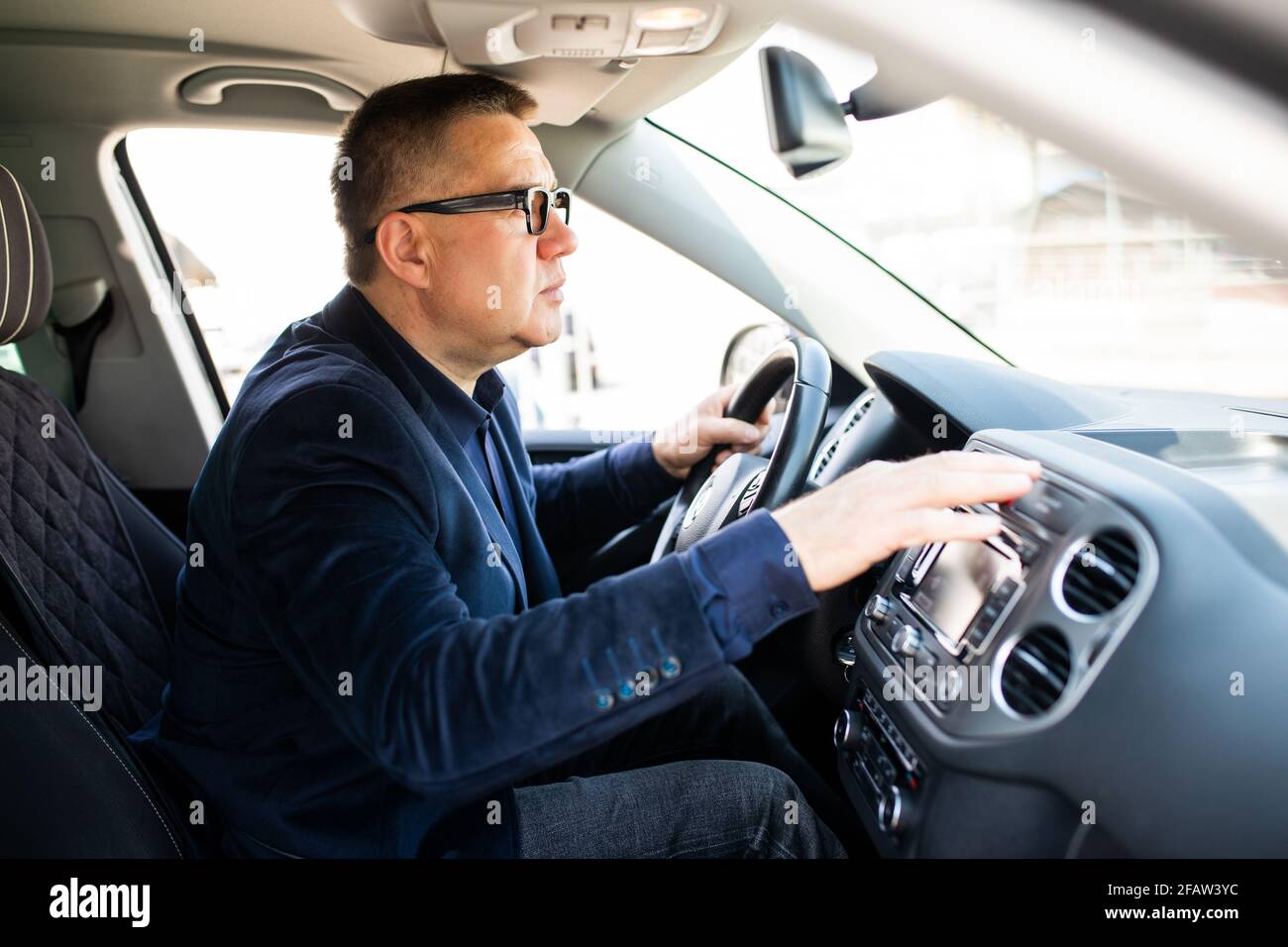 Middle age Man pressing red triangle car hazard warning button Stock Photo