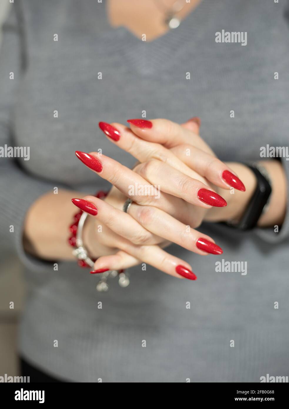 Woman S Hands With Long Nails And A Bottle Of Bright Red Nail Polish Stock Photo Alamy