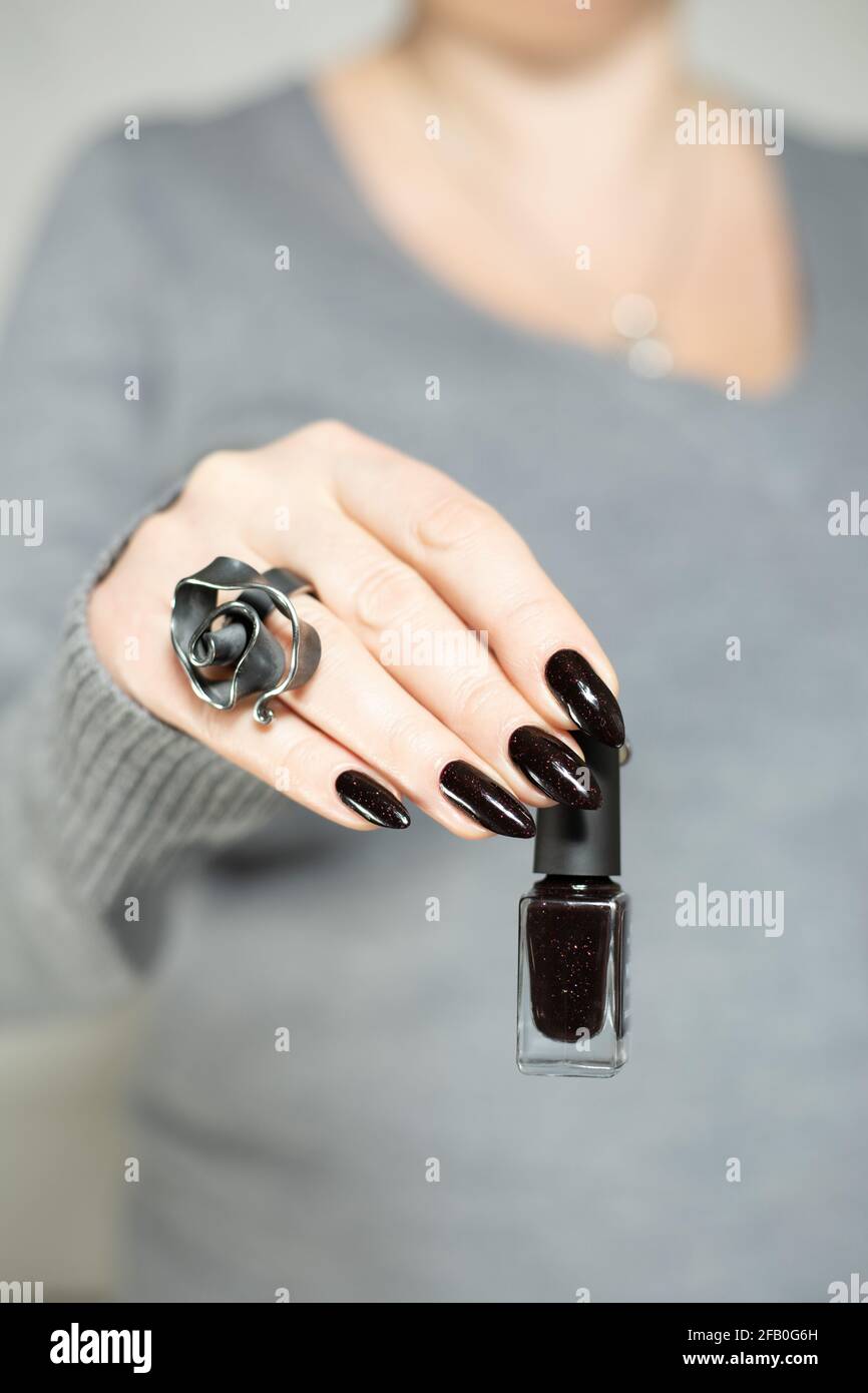 Woman's hands with long nails and black manicure with bottles of nail polish Stock Photo - Alamy Woman's hands with long nails and black manicure with bottles of nail polish Stock Photo - Alamy