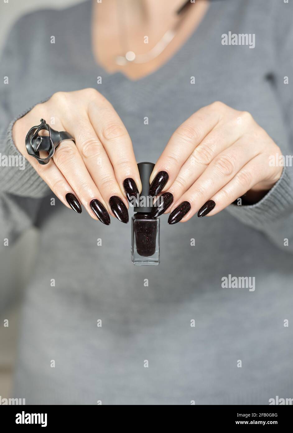Woman's hands with long nails and black manicure with bottles of nail polish Stock Photo - Alamy Woman's hands with long nails and black manicure with bottles of nail polish Stock Photo - Alamy