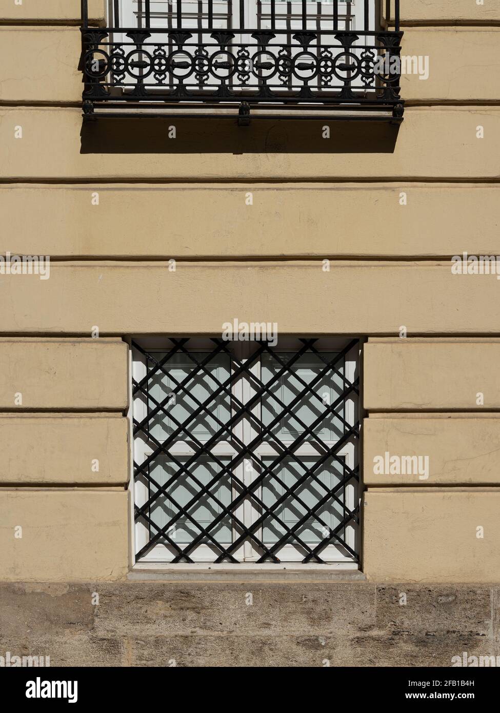 Vintage window with iron grating on a stone wall. Valencia, Spain Stock Photo