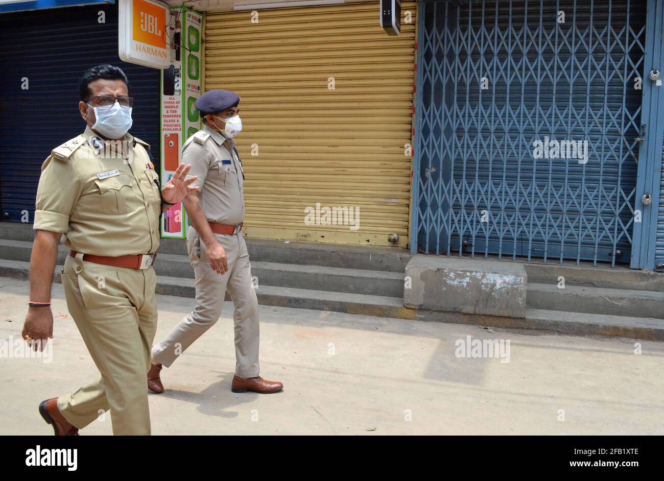 Bangalore, India. 23rd Apr, 2021. Police shut down commercial and non essential shops as new COVID-19 restrictions are imposed to curtail the rapidly spiraling chain of coronavirus infections, in Bangalore, India, April 23, 2021. Credit: Str/Xinhua/Alamy Live News Stock Photo