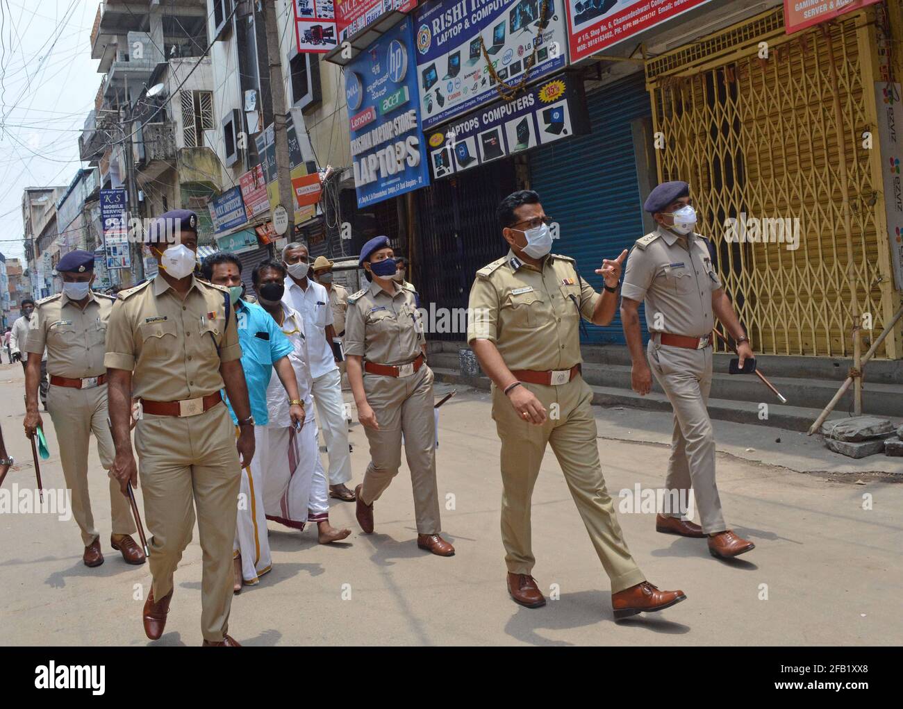 Bangalore, India. 23rd Apr, 2021. Police shut down commercial and non essential shops as new COVID-19 restrictions are imposed to curtail the rapidly spiraling chain of coronavirus infections, in Bangalore, India, April 23, 2021. Credit: Str/Xinhua/Alamy Live News Stock Photo