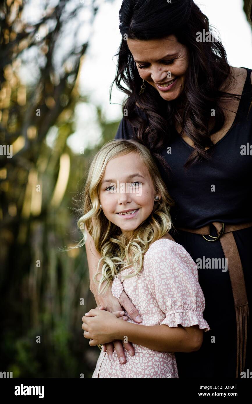 Mother Embracing Young Daughter in San Diego Stock Photo Alamy