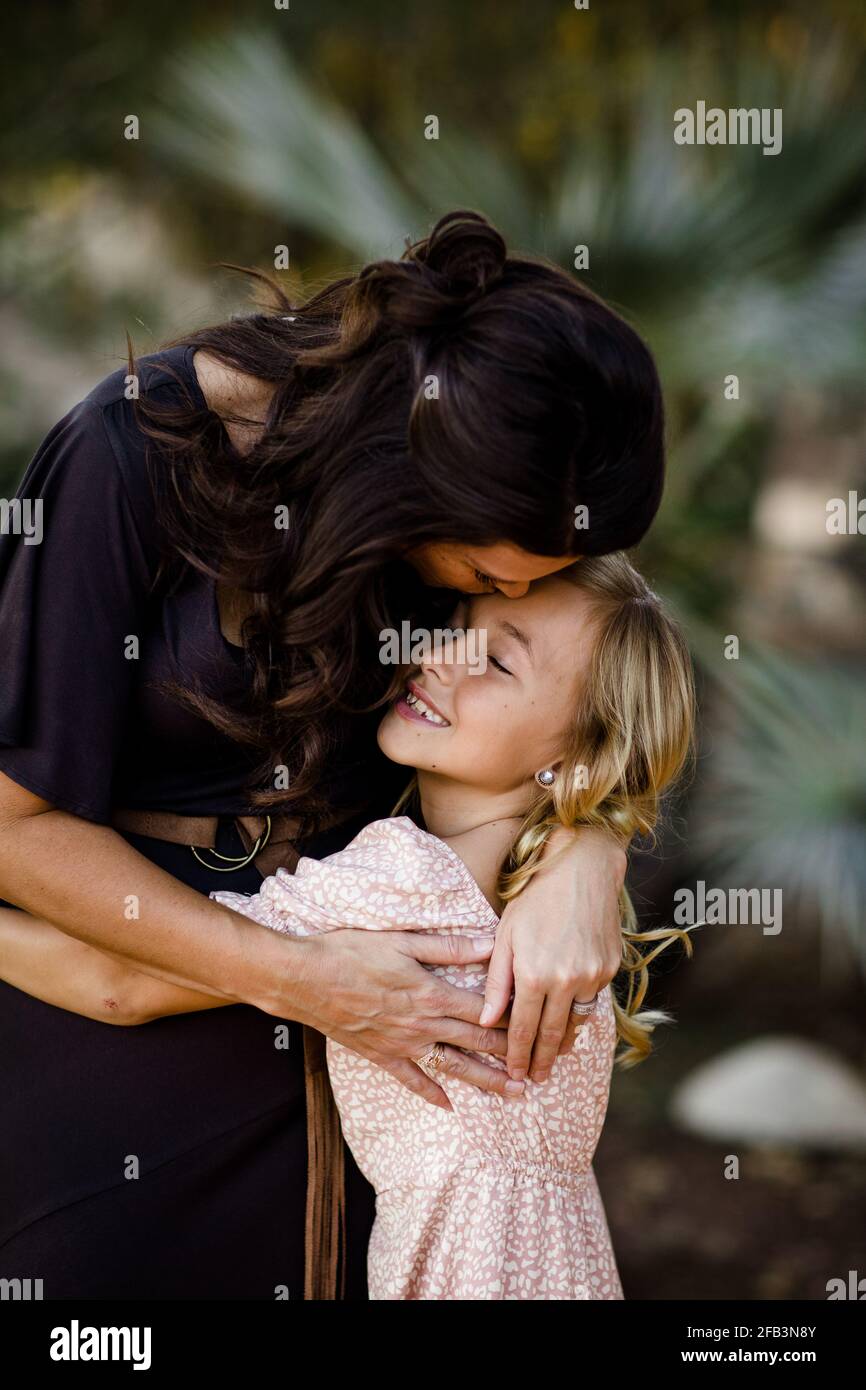 Mother & Young Daughter Hugging in Garden in San Diego Stock Photo Alamy