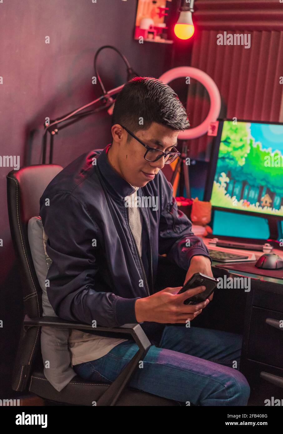 Young man texting with his cell phone to his friends. Stock Photo