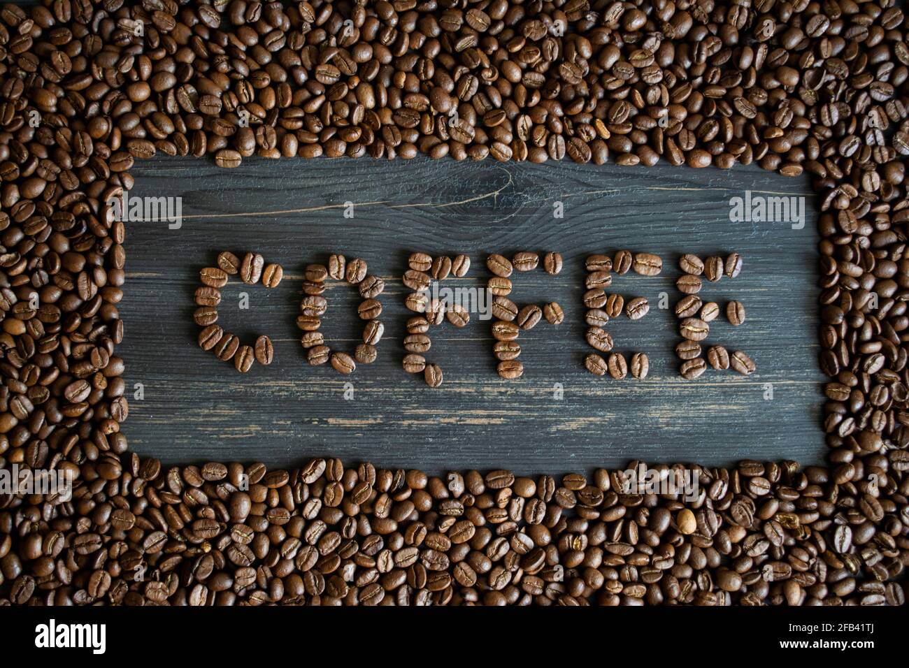 Coffee beans form a word on a coffee beans background Stock Photo