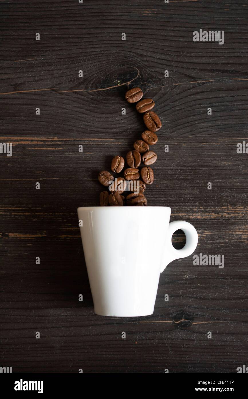Cup with coffee beans on the black background Stock Photo