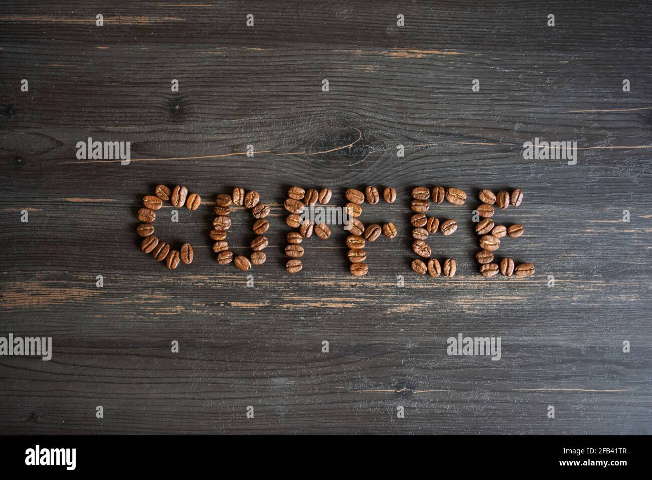 Coffee beans form a word on a black background Stock Photo