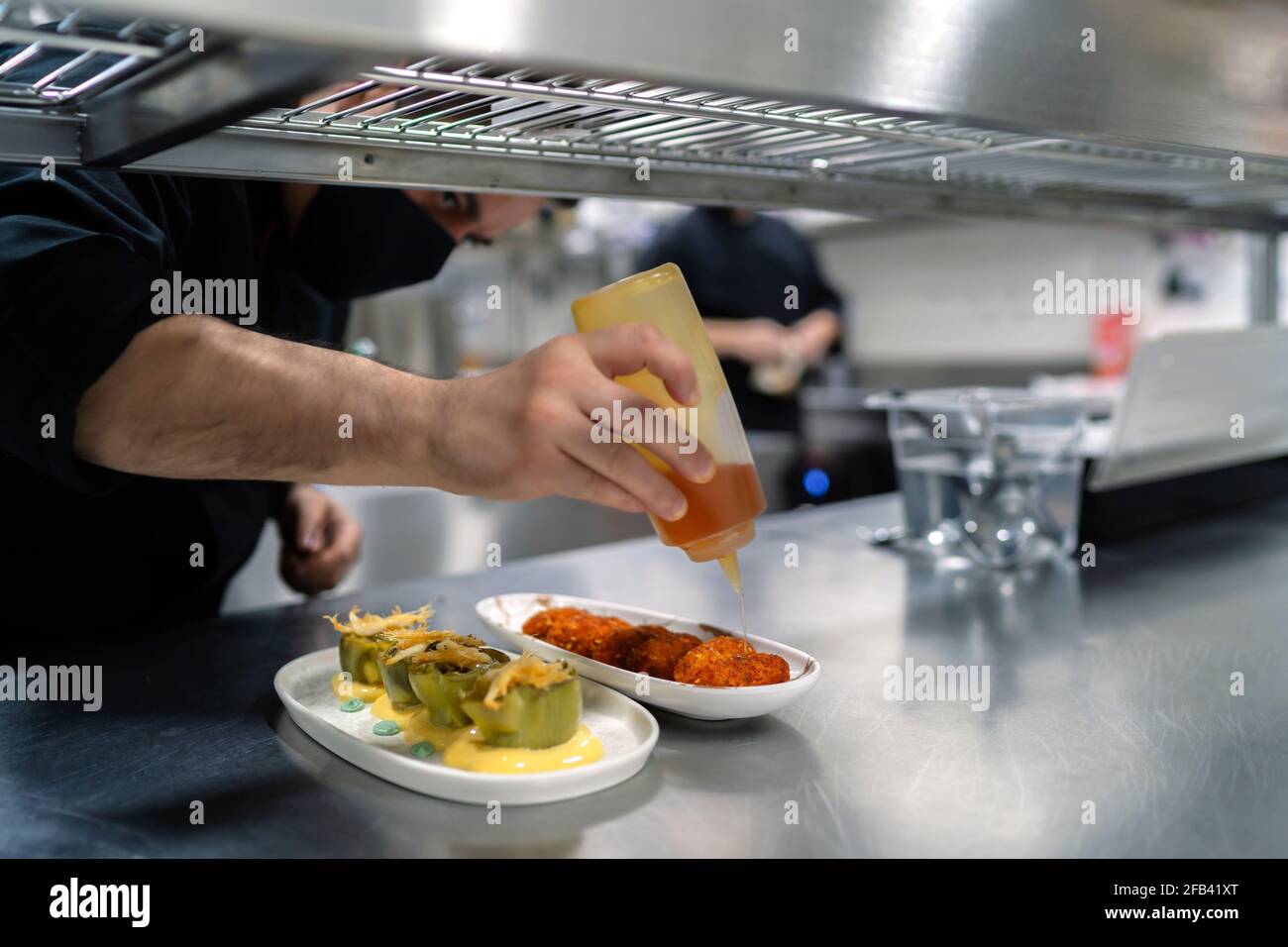 chef putting sauce on his delicious recipes Stock Photo Alamy