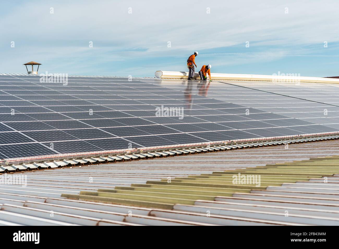 Unrecognizable solar panel technicians working on a Spanish factory Stock Photo