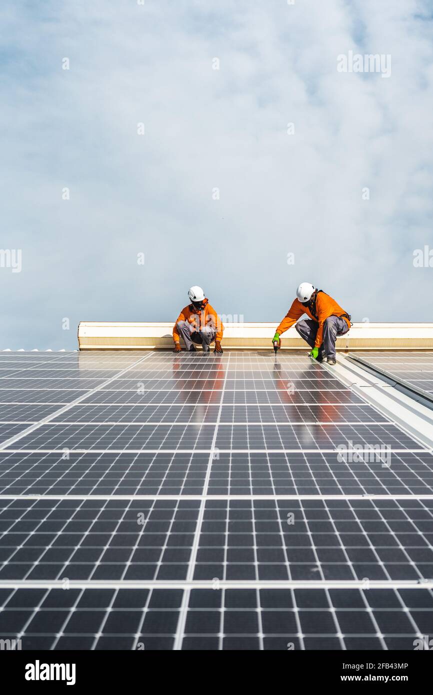Unrecognizable solar panel technicians working a Spanish factory Stock Photo