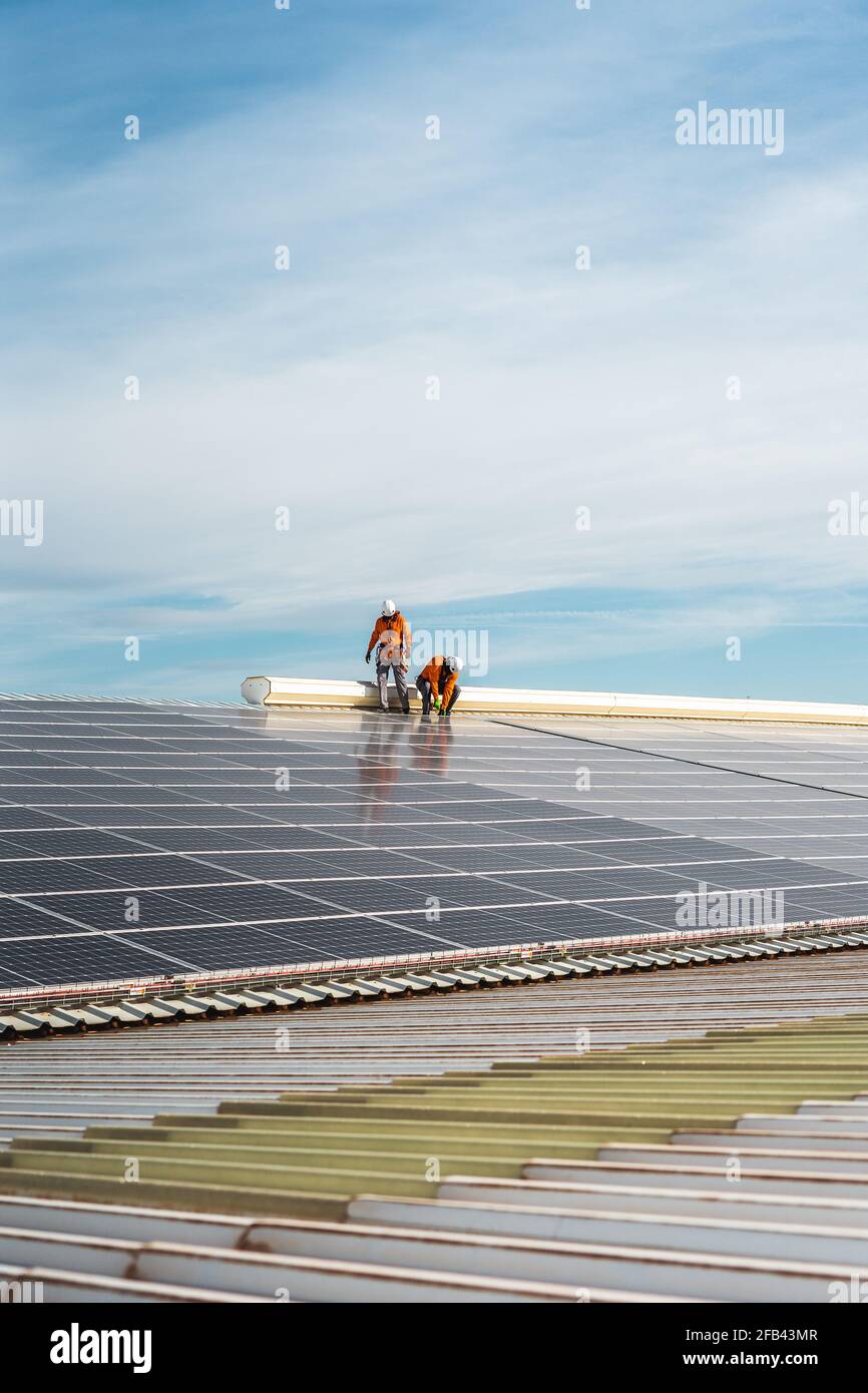 Unrecognizable solar panel technicians working a Spanish factory Stock Photo