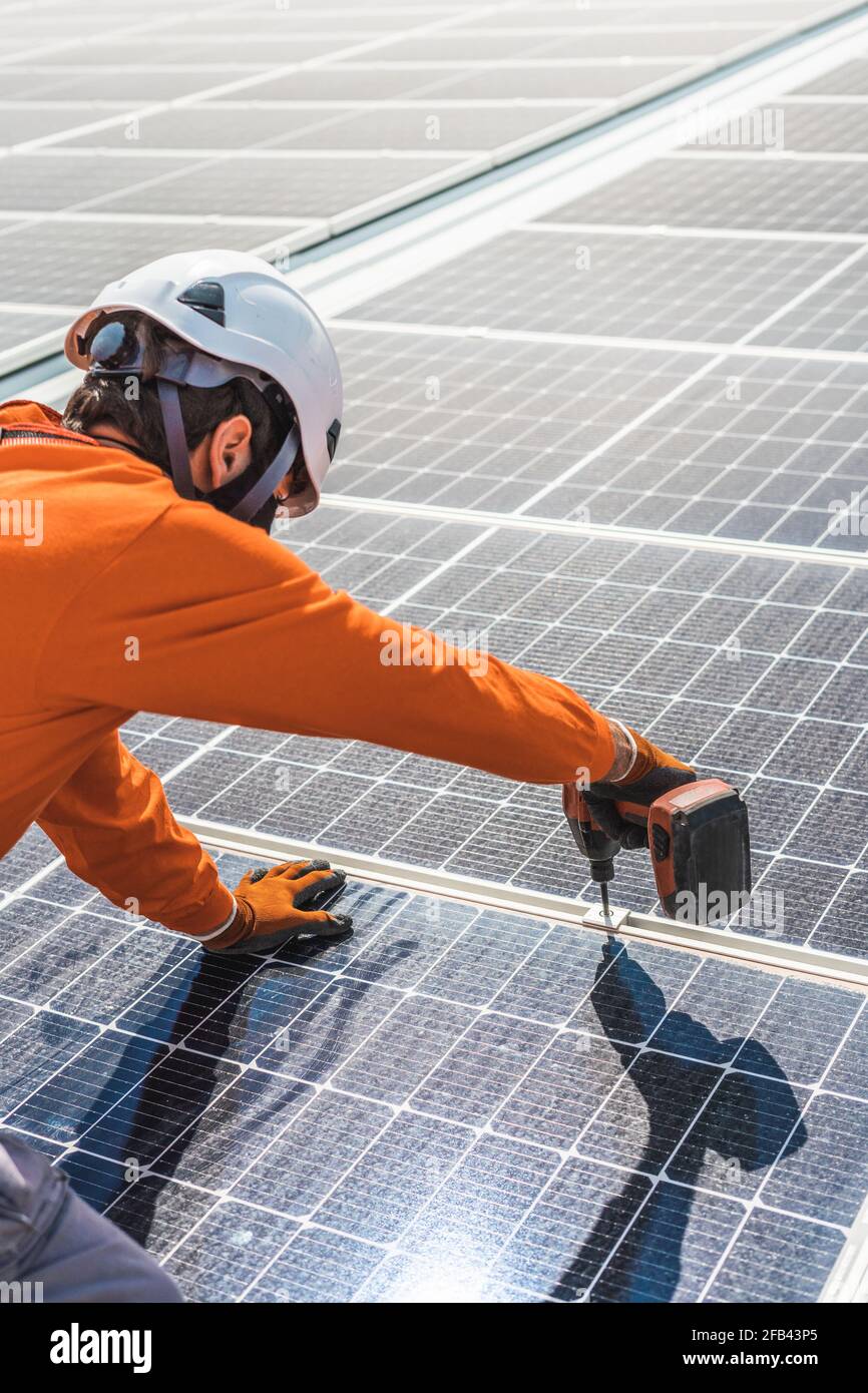 Unrecognizable solar panel technicians working in Spanish installation Stock Photo