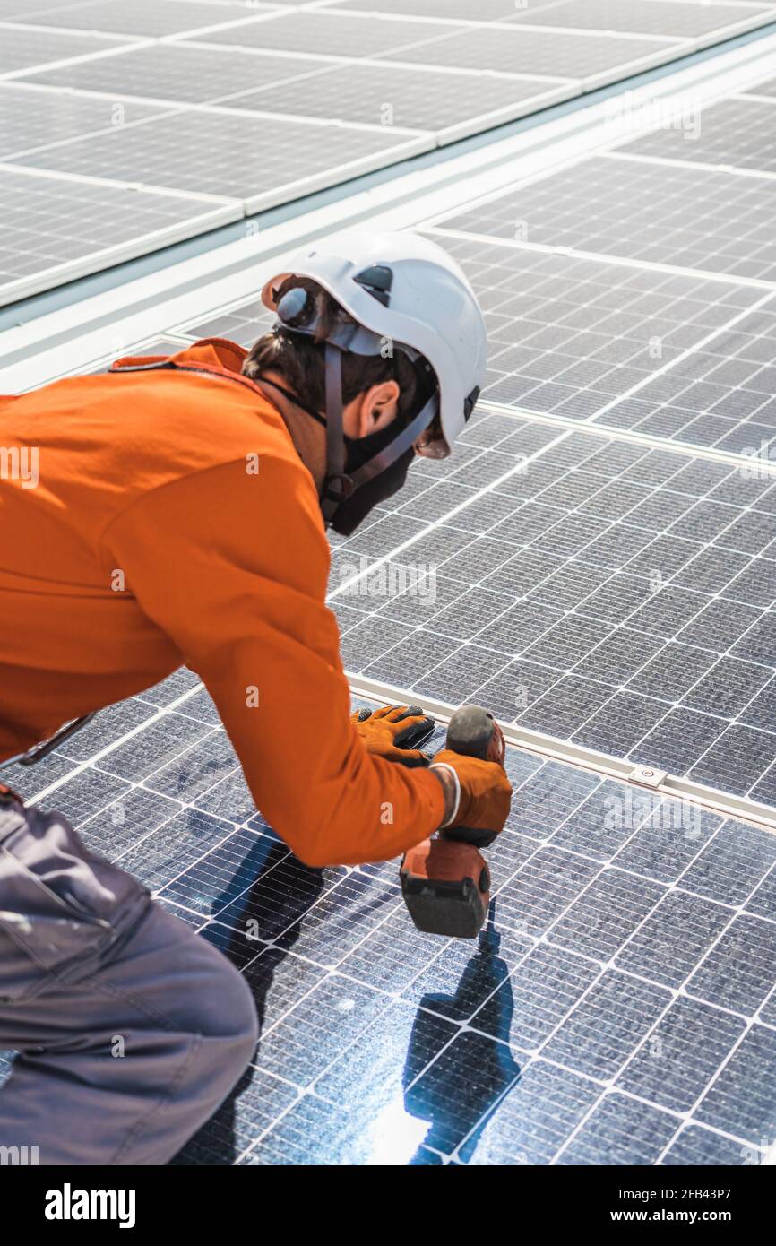 Unrecognizable solar panel technician working in Spanish installation Stock Photo