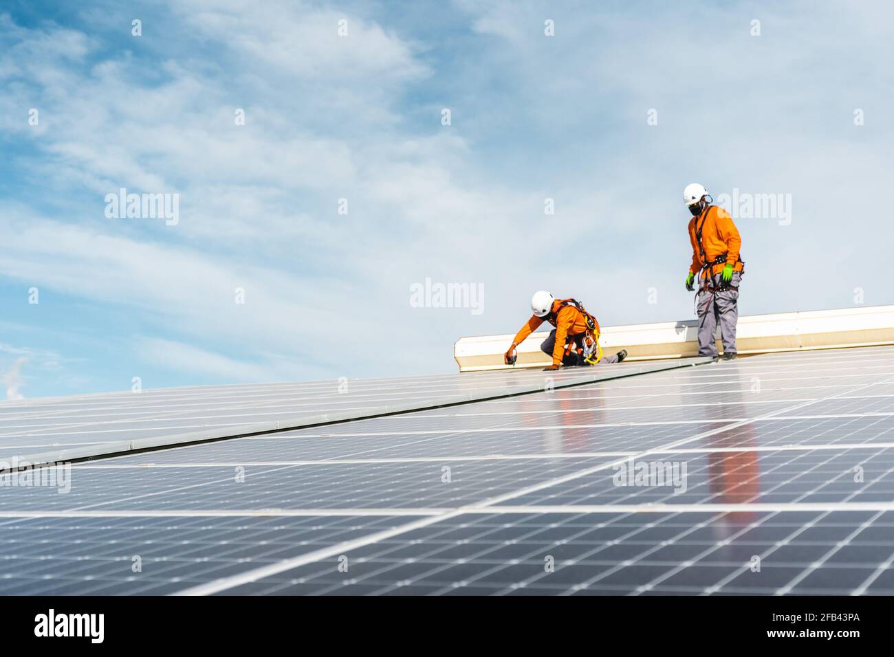 Unrecognizable solar panel technicians working in Spanish installation Stock Photo