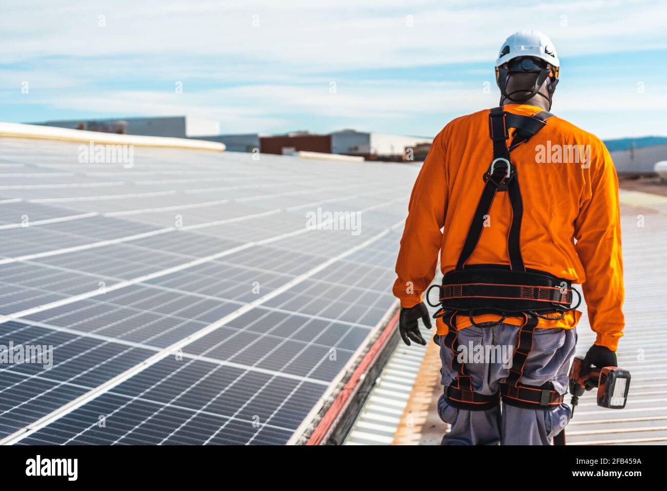 Unrecognizable solar panel technician walking in Spanish installation Stock Photo
