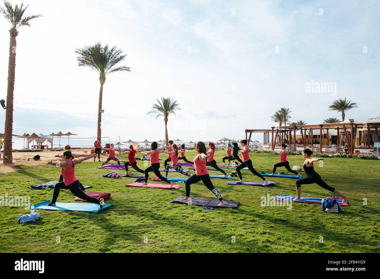 Group of tourists doing yoga outdoors in the hotel Stock Photo - Alamy