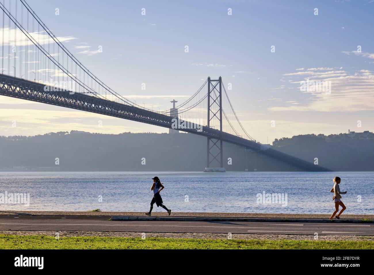 Dawn on the banks of the Tagus river, near the 25th of April bridge. Lisbon, Portugal Stock Photo