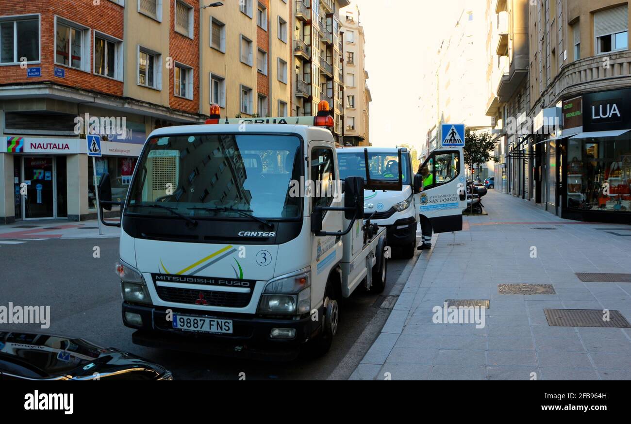 Parked ready to start working pair of municipal tow trucks early morning Santander Cantabria Spain Stock Photo