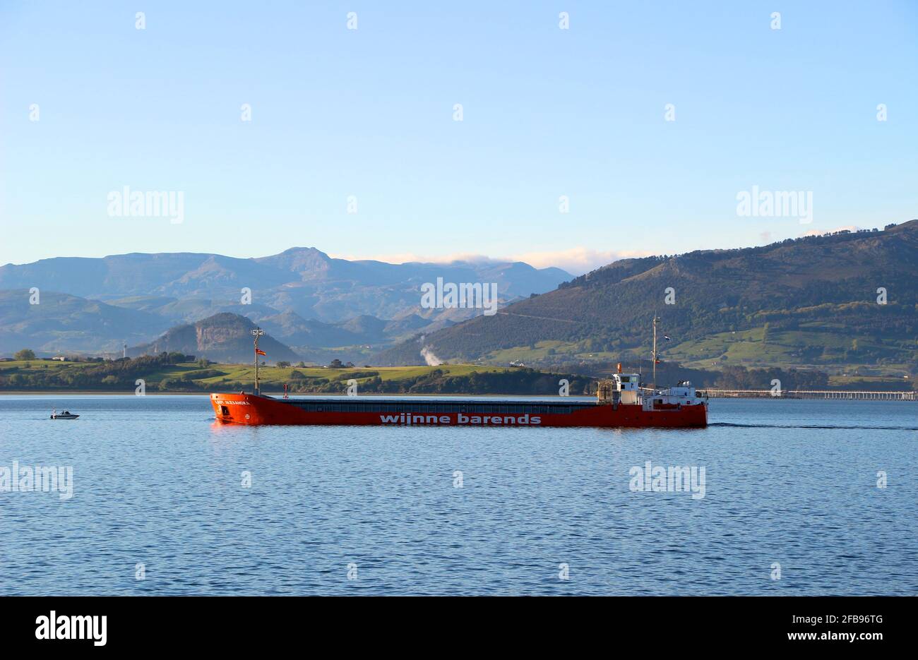 The Lady Alexandra Dutch cargo ship leaving the port of Santander Cantabria Spain in the bay on a calm sunny spring morning Stock Photo