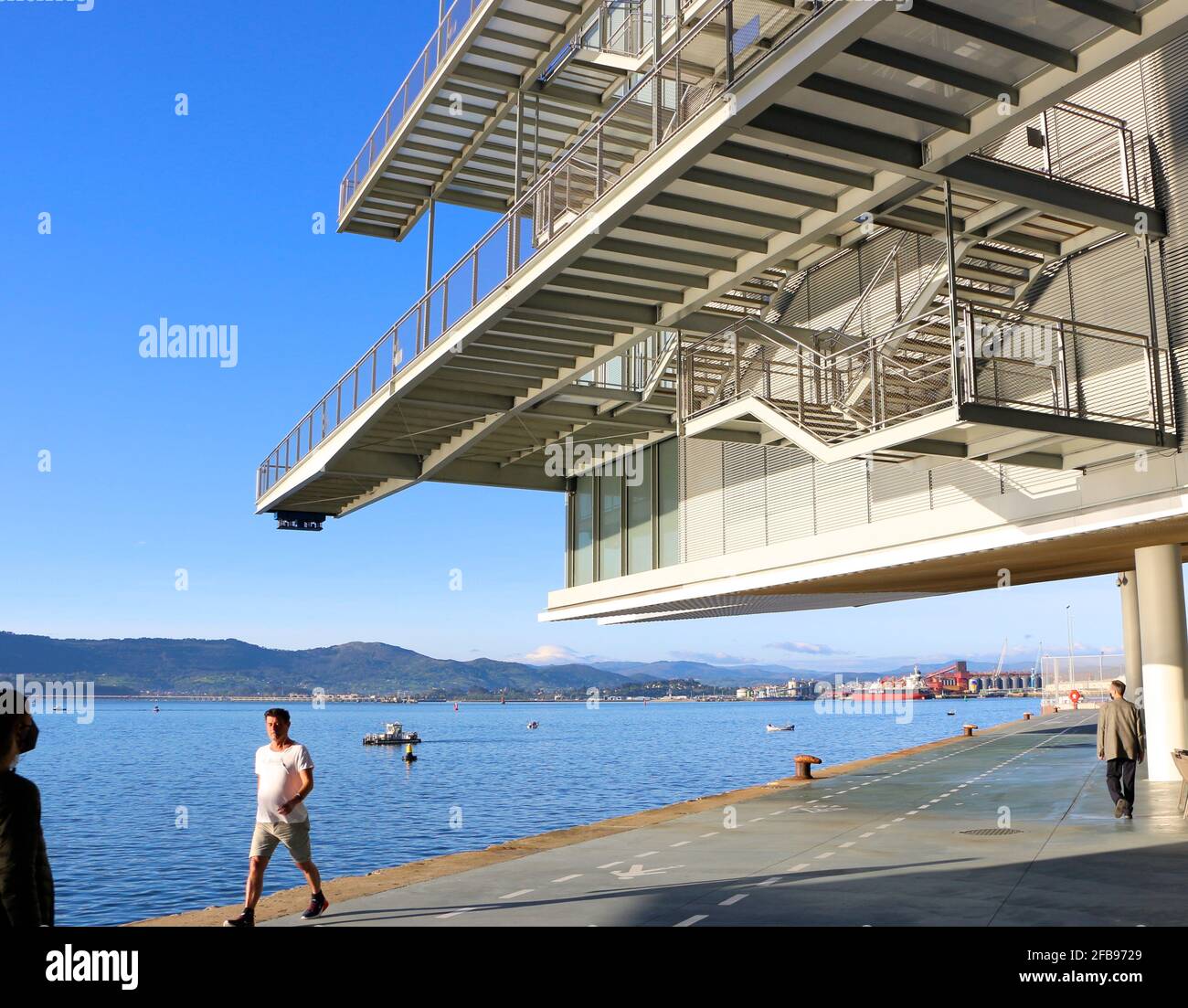 People out for a morning walk under walkways at the Centro Botin Centre Arts Centre designed by Renzo Piano in Santander Cantabria Spain Stock Photo