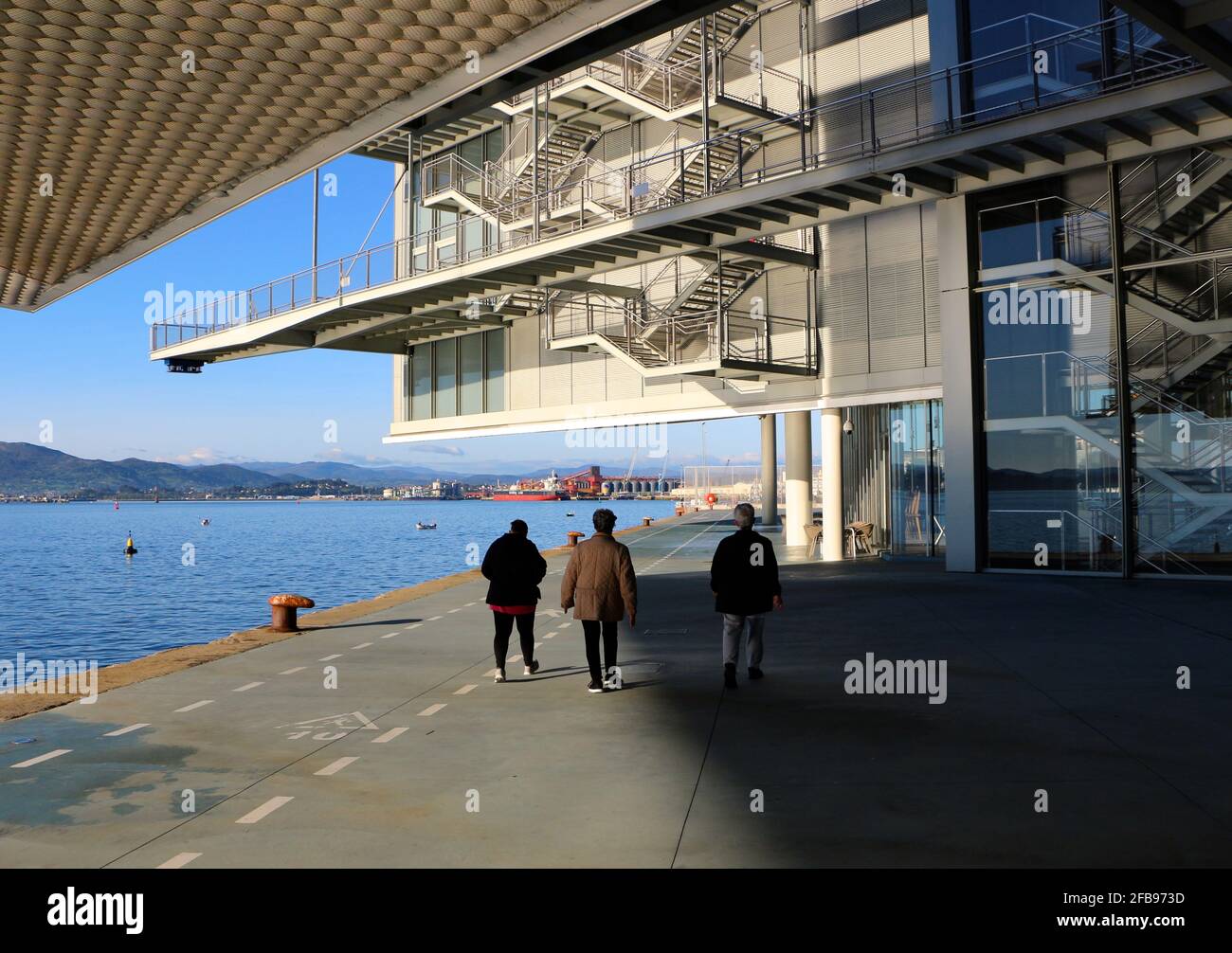 People out for a morning walk under walkways at the Centro Botin Centre Arts Centre designed by Renzo Piano in Santander Cantabria Spain Stock Photo