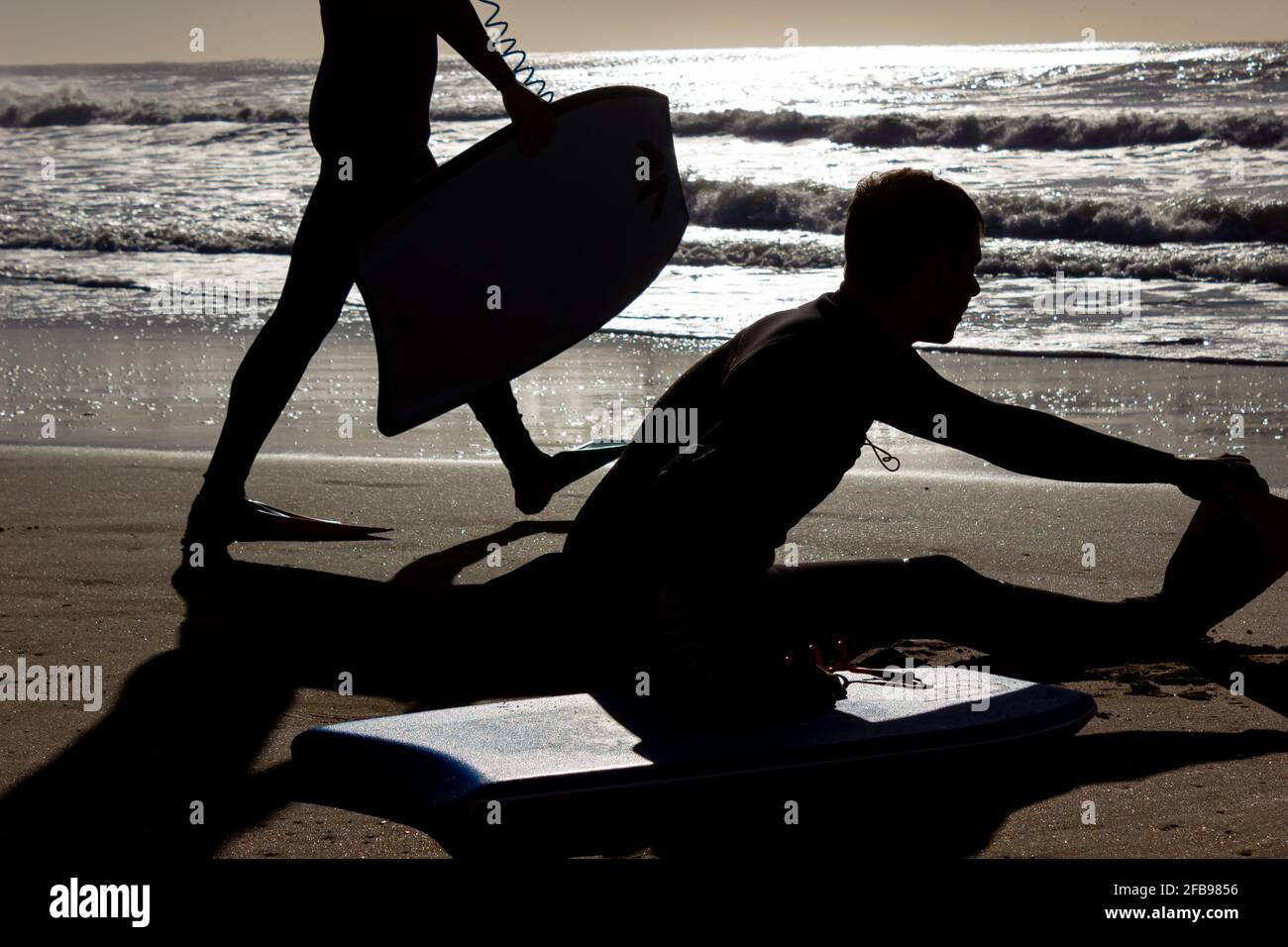 Man preparing to surf on a sunny day. Stock Photo