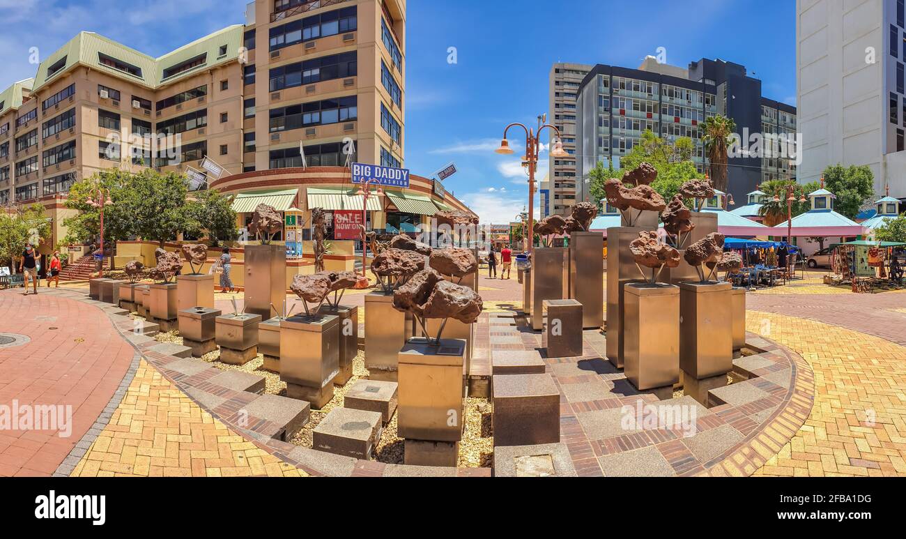 WINDHOEK, NAMIBIA - JAN 18, 2021: Panorama of the Gibeon Meteorites at the Center of Windhoek, background buildings Stock Photo