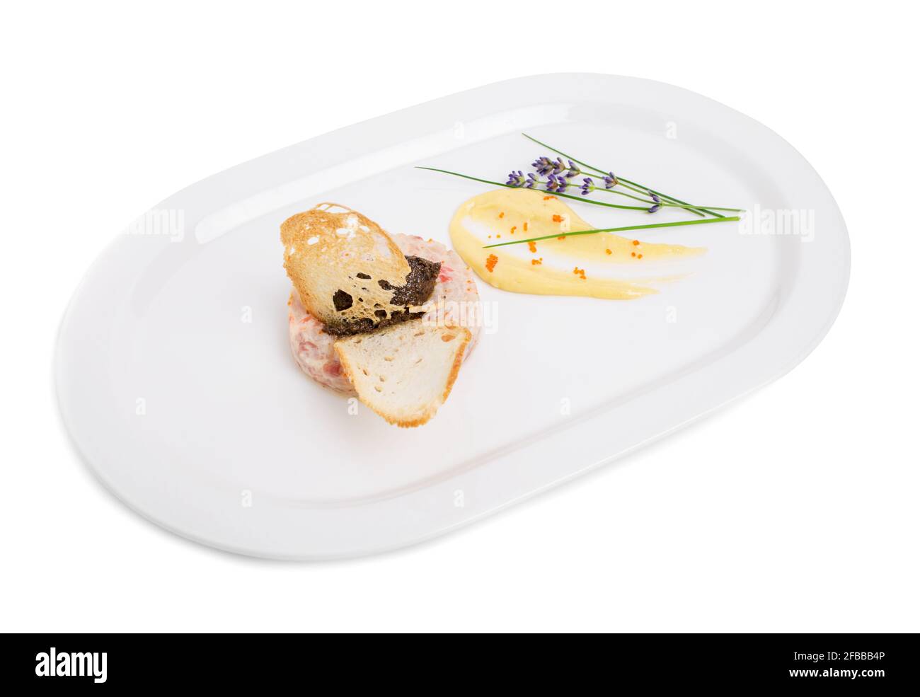 Salmon tartare with black truffle sauce and delicious mousse. Isolated