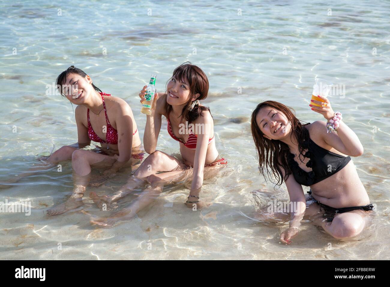 Three Young Japanese Females Drinking And Relaxing In The Shallow Emerald Blue Water On Yonaha Maehama Beach Miyakojima Okinawa Japan Stock Photo Alamy