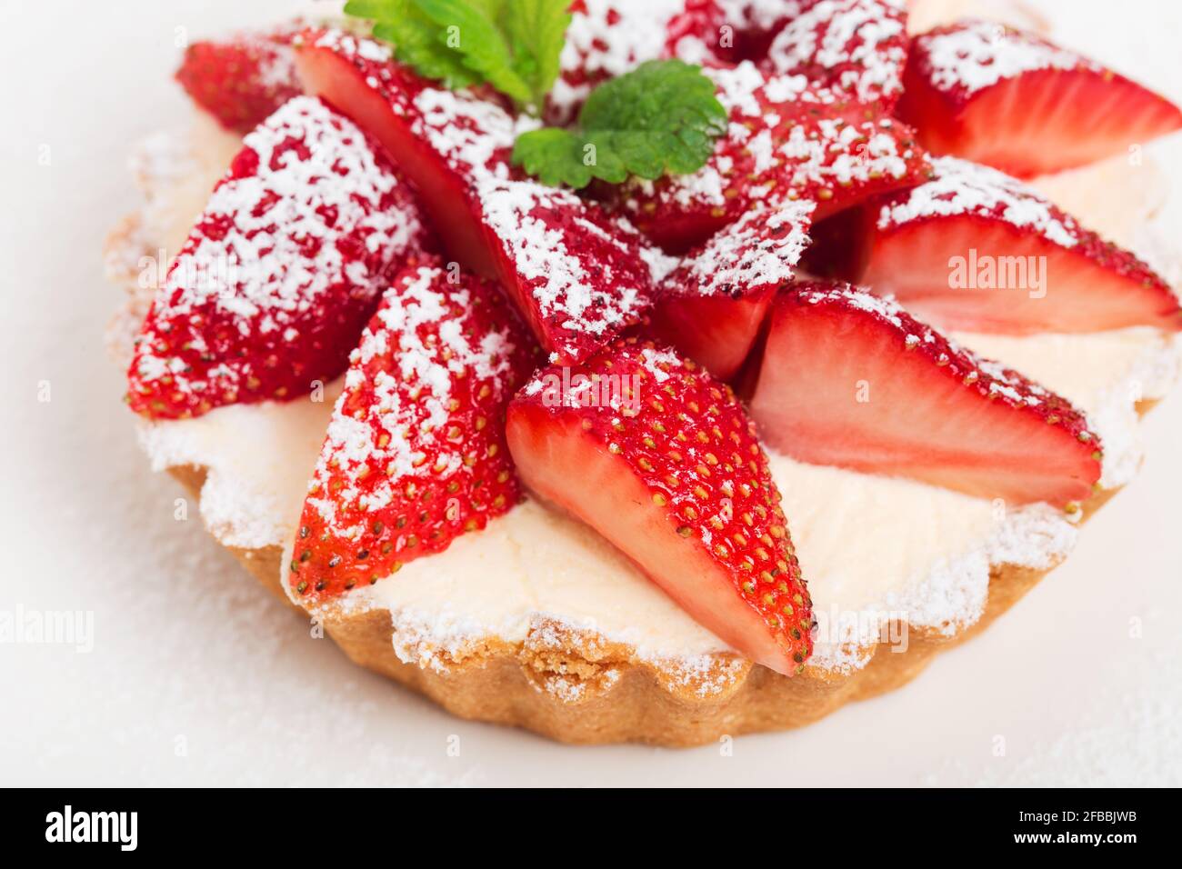 Delicious strawberry shortcake with whipped cream and fresh mint. Macro ...