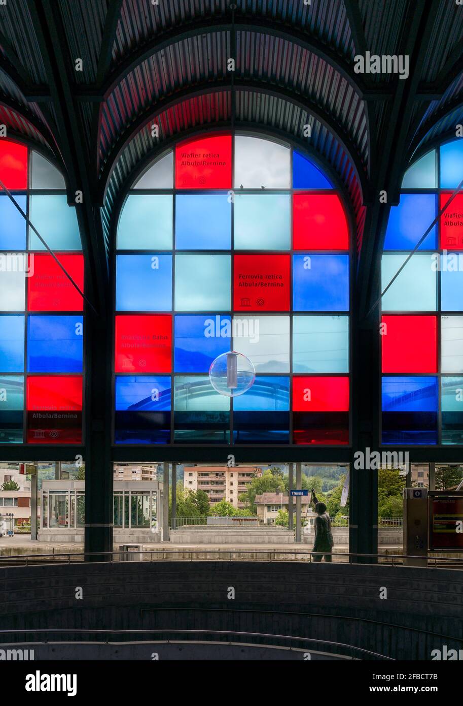 Coloured windows in Thusis station Stock Photo