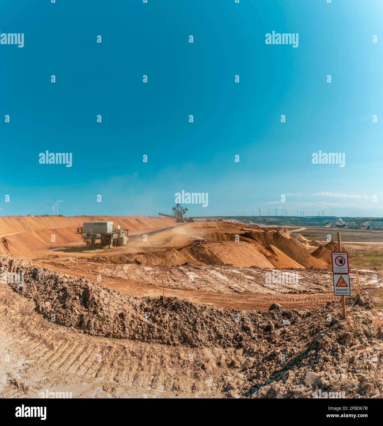 Clear blue sky over open-pit mine Stock Photo