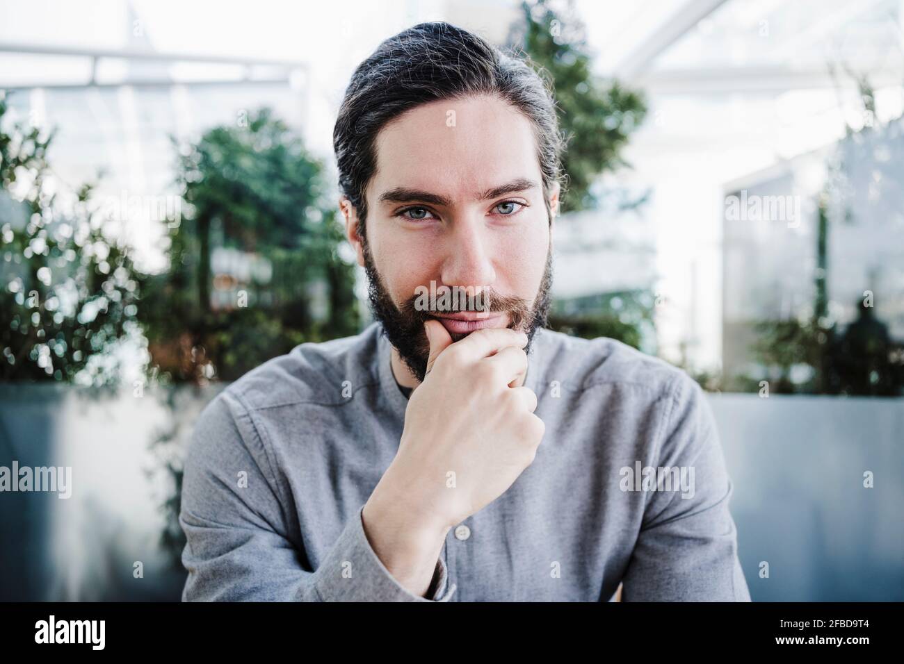 Handsome male businessperson with gray eyes at work place Stock Photo