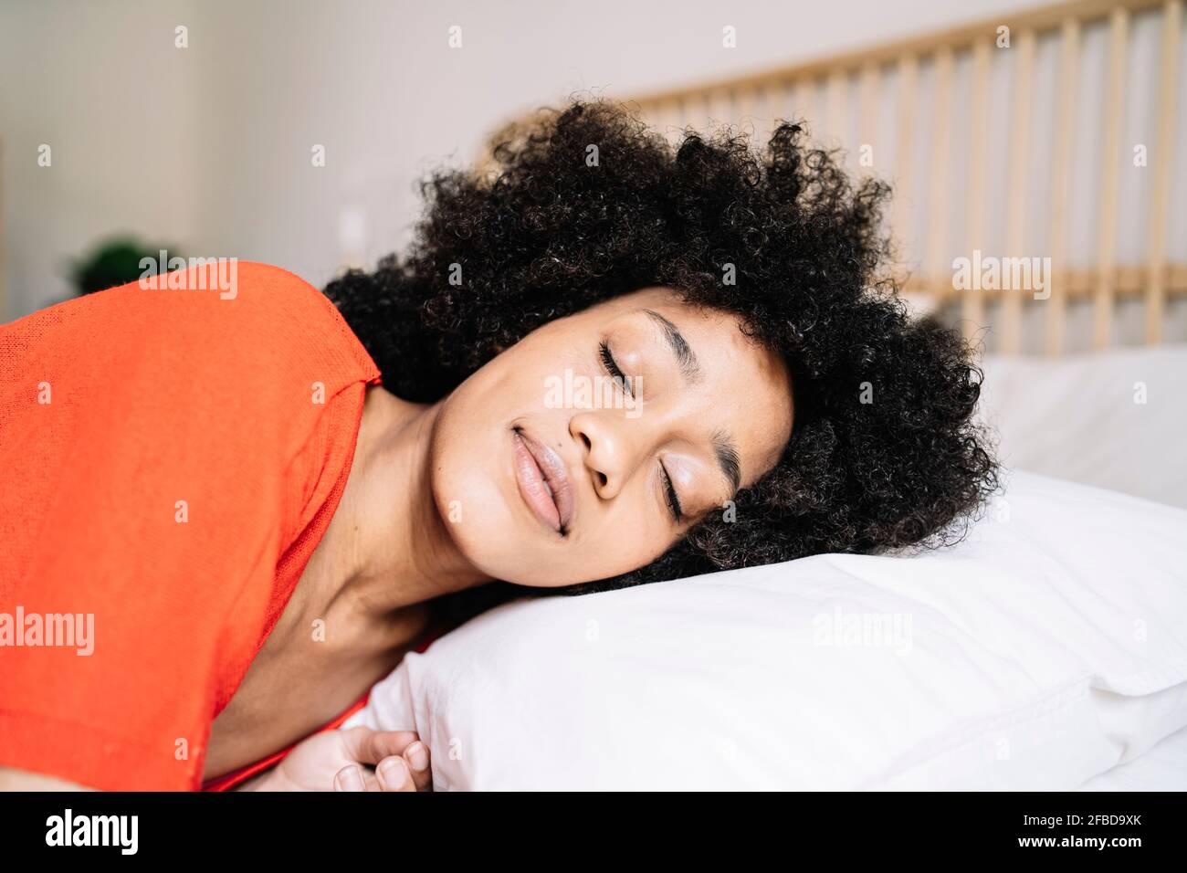 Young woman sleeping on bed at home Stock Photo
